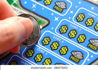 Coquitlam BC Canada - June 02, 2015 : Woman scratching lottery tickets. The British Columbia Lottery Corporation has provided government sanctioned lottery games in British Columbia since 1985. 