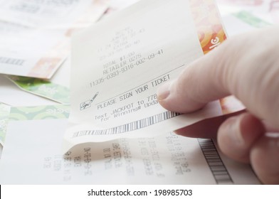 Coquitlam BC Canada - May 31, 2014 : Close Up People Holding A Winning Lottery Ticket. The BC Lottery Corporation Has Provided Government Sanctioned Lottery Games In British Columbia Since 1985. 