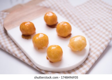 Coquitos Coconut Balls With Caramel On Marble Board On Squared Rag On White Marble