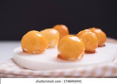 Coquitos Coconut Balls With Caramel On Marble Board On Squared Rag On White Marble