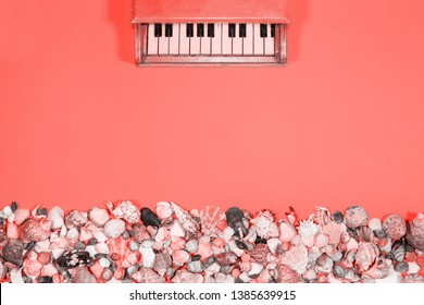 Coral background with seashells bed and small piano