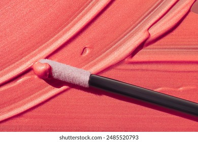 Coral blush red cosmetic smudge glittering satin finish lip gloss swatches with applicator brush isolated on white - Powered by Shutterstock