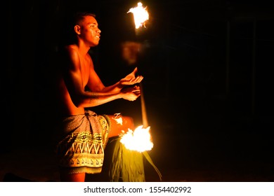 Coral Coast/Fiji - April 9, 2016: Male Fire Dancer Smiling As He Spins His Flaming Baton