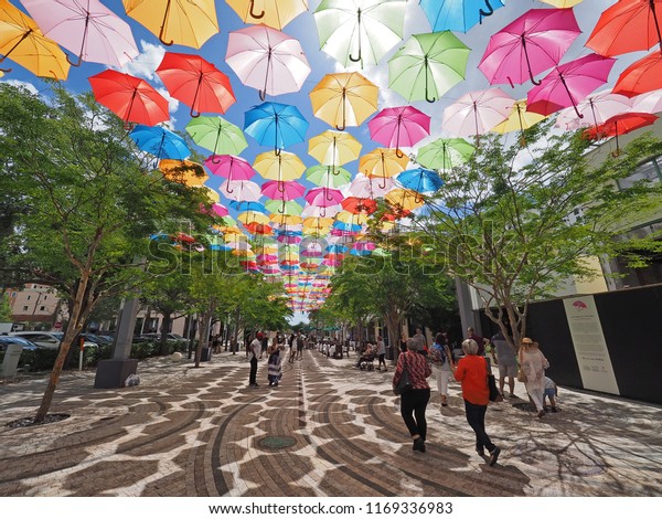 Coral\
Gables, Florida - 08/04/2018: Umbrella Sky in Giralda Plaza in\
Coral Gables, Florida, a joint art project by the City of Coral\
Gables and the Portuguese company Sextafeira.\
