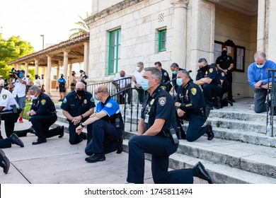 Coral Gables, Florida - May 30, 2020: Police Kneeling Along Side Out Of View Protesters During Protest For George Floyd