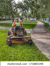 Coral Gables, Florida/USA - April 30, 2020: Mowing Lawn During Pandemic