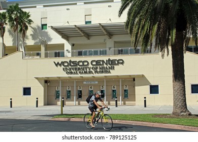 Coral Gables FL/USA: Nov 30, 2017 – Male Bicyclist Rides By Box Office Entrance To Watsco Center Which Is Home To The University Of Miami Hurricanes Basketball Teams. 