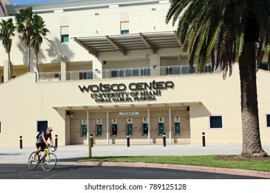 Coral Gables FL/USA: Nov 30, 2017 – Male Bicyclist Rides By Box Office Entrance To Watsco Center Which Is Home To The University Of Miami Hurricanes Basketball Teams. 