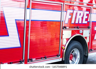 Coral Spring, FL / USA - 2/22/2020: Closeup of a red firetruck known as Engine 71 of the Coral Springs / Parkland Fire Department which includes a paramedic, extension ladder, water, hoses and lights 