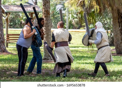 Coral Springs, Florida / USA - 10/6/2019: Grown Men Some In Costume With Fake Swords And Shields Practice Battling In Orchid Park For Renaissance Fair Festival. Live Action Role Play Aka LARPing