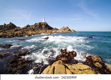 Corbiere Lighthouse and the rocky coast in Jersey, The Channel Islands