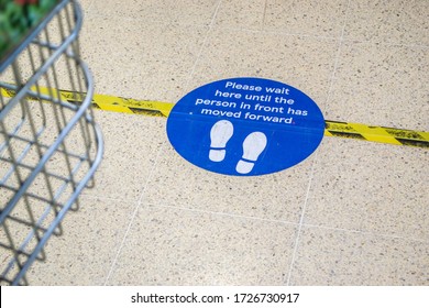 CORBY/ENGLAND- 7 MARCH 2020: Social distancing floor sticker in Tesco in Corby, during the Coronavirus 2020 lockdown