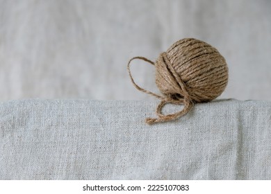 Cord Skein Of Natural Hemp On The Hemp Fabric Background. Natural Fibers.