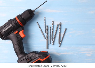 Cordless Drill Featuring Various Drill Bits Set Against a Vibrant Blue Background