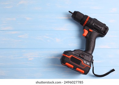 Cordless Drill Featuring Various Drill Bits Set Against a Vibrant Blue Background