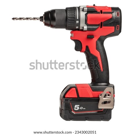 Cordless drill isolated on white background. New red cordless screwdriver with drill bit inserted, side view. Cordless power tool for drilling on a white background.