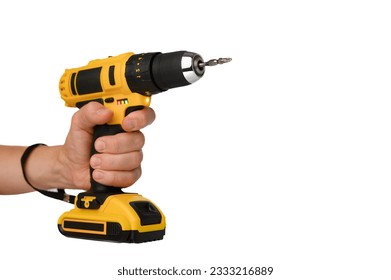 Cordless electric yellow screwdriver drill in hand isolated on white background. Close-up. - Powered by Shutterstock