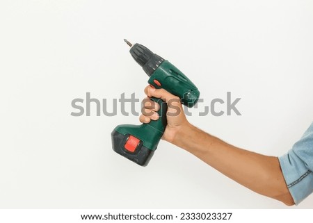 Cordless screwdriver holding by hand with isolated white background.