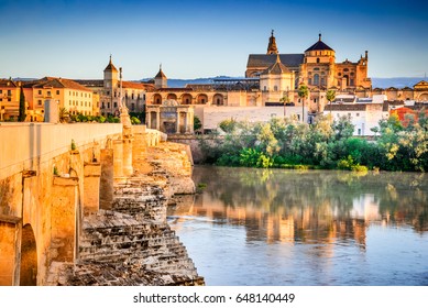 Cordoba, Spain. Roman Bridge on Guadalquivir river and The Great Mosque (Mezquita Cathedral) at twilight in the city of Cordoba, Andalusia. - Shutterstock ID 648140449