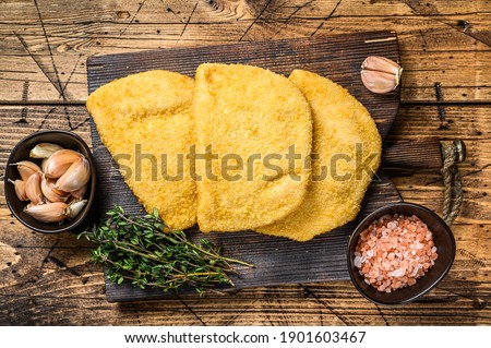 Cordon bleu meat cutlets with bread crumbs on a wooden board. wooden background. Top view.