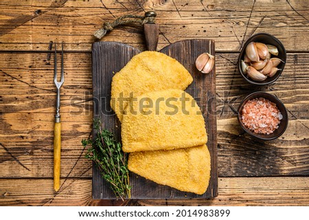 Cordon bleu meat cutlets with bread crumbs on a wooden board. wooden background. Top view