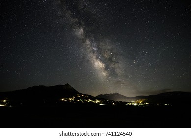 The Core Of The Milky Way Galaxy Seen On A Clear Night Above A Small Mountain Town In North America.