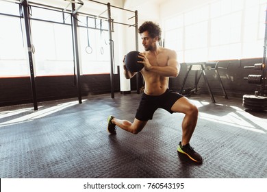 Core Strength And Stability Workout. Fit And Muscular Man Exercising With Medicine Ball At Gym.