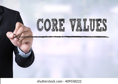 CORE VALUES Businessman Drawing Landing Page On Blurred Abstract Background