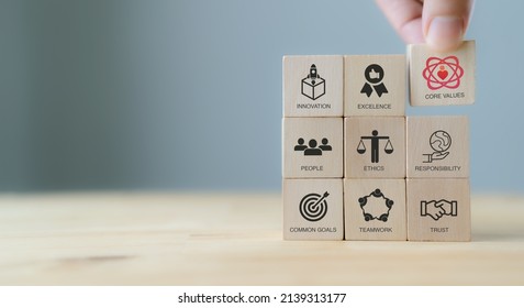 Core values,corporate values concept.  Company culture and strategy related to business and customer relationships, growth. Principles guide company's action. Put wooden cubes with core values icons. - Shutterstock ID 2139313177