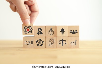 Core values,corporate values concept.  Company culture and strategy related to business and customer relationships, growth. Principles guide company's action. Put wooden cubes with core values icons.