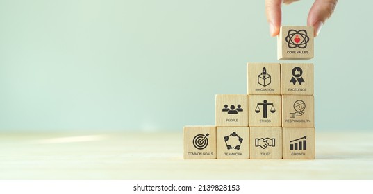 Core values,corporate values concept.  Company culture and strategy related to business and customer relationship, growth. Principles guide company's action. Stack wooden cubes with core values icons.