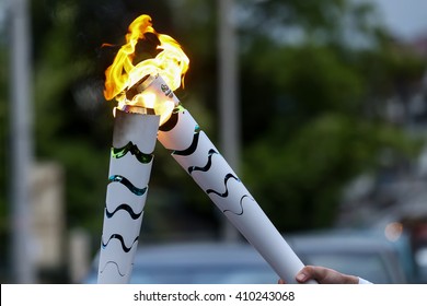 Corfu, Greece - April 23, 2016: The Olympic flame is symbolically passed from one torch to another after the official ceremonial lighting