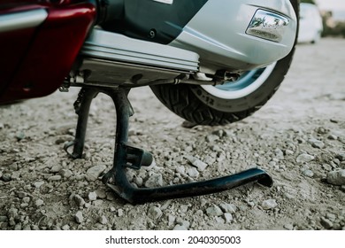 Corfu, Greece - September 2021. Red Retro Vespa Scooter On Center Two Legged Kickstand. Close-up View To Motor Bike Rear Wheel