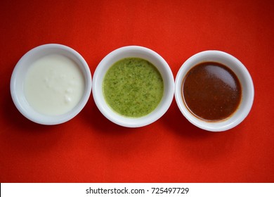 Coriander Chutney And Tamarind Chutney With Curd.