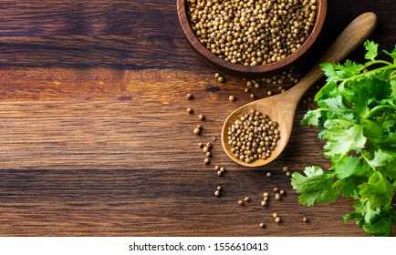 Coriander Seed And Leaf On Wood Background 