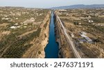 Corinth Canal, Greece. The Corinth Canal is a sluiceless shipping canal in Greece, connecting the Saronic Gulf of the Aegean and the Gulf of Corinth of the Ionian Sea, Aerial Viewdefault