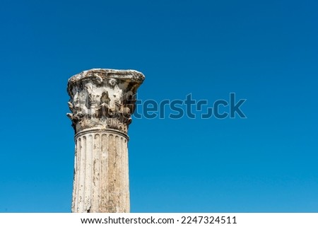 Corinthian column head of atrium house in Priene, Aydın, Turkey with blue sky on the background. Copy space for text. Corinthian column capital with acanthus ornament.	
