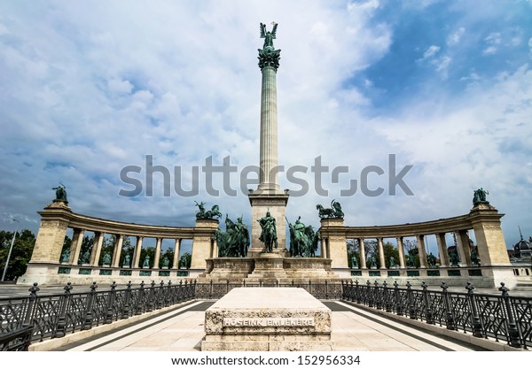 Corinthian column topped with Archangel Gabriel\
holding St. Stephen\'s crown.At the base: Arpad and the chieftains\
of the seven Magyar tribes. Behind the column: kings and heroes\
from Hungarian\
history