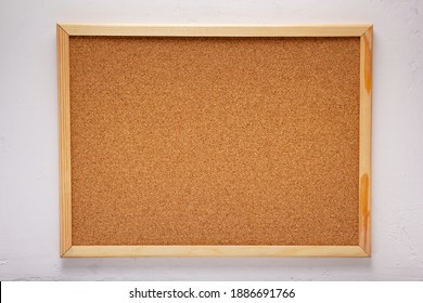 cork board or corkboard at white concrete or putty  wall background texture surface