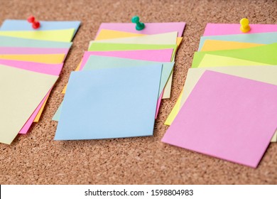 Cork board with several colorful blank notes with pins - Shutterstock ID 1598804983