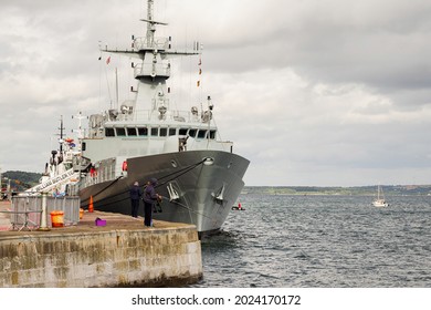 Cork, Ireland - 07.08.2021: LÉ William Butler Yeats (P63) Patrol Ship Of Irish Naval Force By A Pier In Cobh. People Fishing Near By. Cloudy Sky.