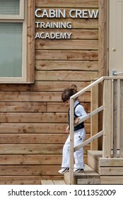 CORK, IRELAND - July, 20th, 2012: Little Girl In A Front Of Cabin Crew Training Academy In A Cork Airport 