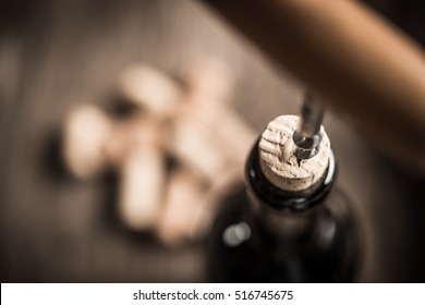 Cork Screw And Wine BottleOpening A Wine Bottle With A Corkscrew In A Restaurant