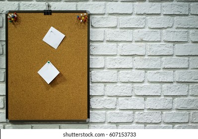 Corkboard With Paper Placed On White Wall Brick Background