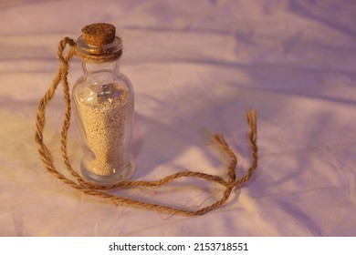 Corked Pirate Bottle Full Of Shell Sand With Rope Tied To It