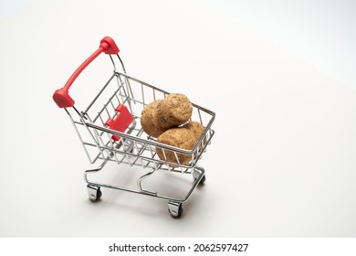 Corks with mini cart supermarket on white background. Concept of delivery, online shopping. Copy space. High quality photo