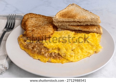 corn beef hash omelette served with hash browns and toast