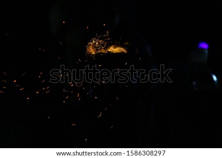 Corn being cooked on coal near beach with some fire spark . A corn roaster sparkling fire in the shores of Marina Beach, Chennai, India on night