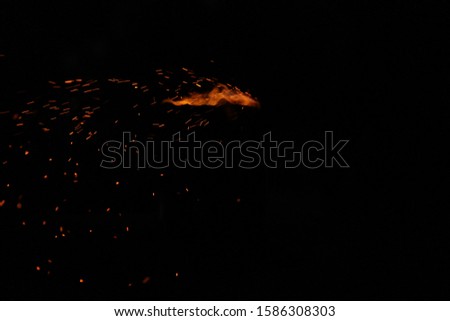 Corn being cooked on coal near beach with some fire spark . A corn roaster sparkling fire in the shores of Marina Beach, Chennai, India on night