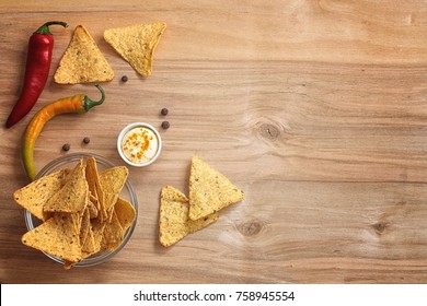 Corn Chips In The Jar. Traditional Snack For Beer Mexican Nachos. Nachos With Spices And Pepper On Wooden Table.